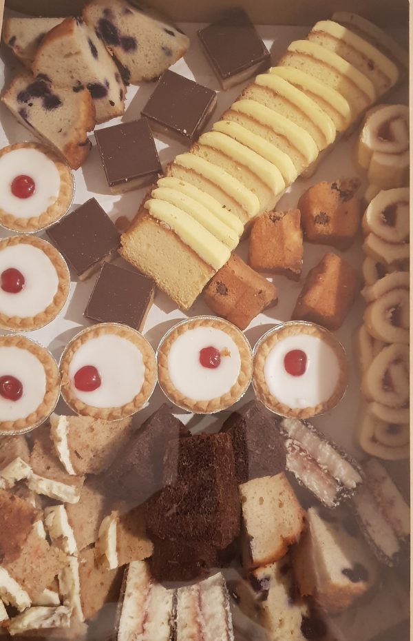 A large box containing assorted cake slices
