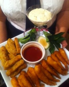 A plate of cooked fingerfoods with dip