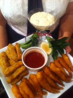 A plate of cooked fingerfoods with dip