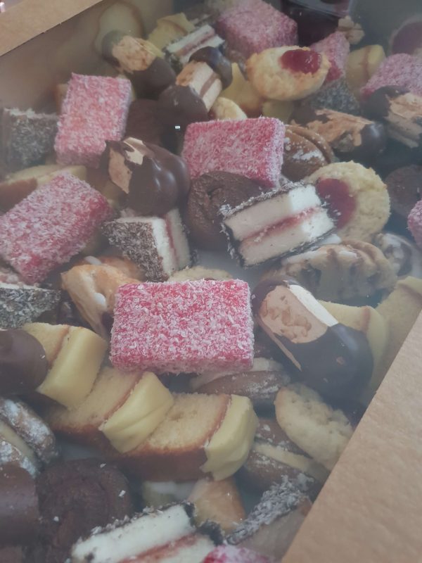 Large selection of sweet treats, including lamingtons, cake slices and biscuits